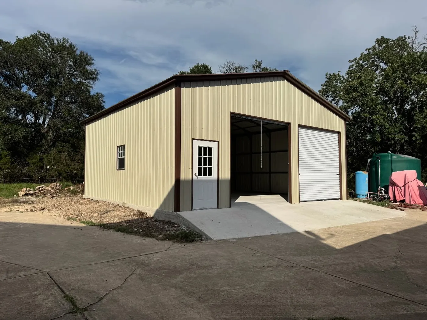 Completed light-metal building with open bay and roll-up door